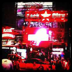 People on illuminated street at night