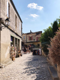 Street amidst buildings in city against sky