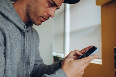 Midsection of man using mobile phone