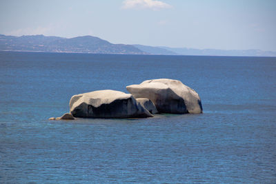 Scenic view of sea and mountains against sky