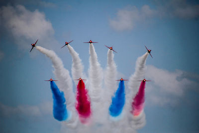 Low angle view of airshow against sky