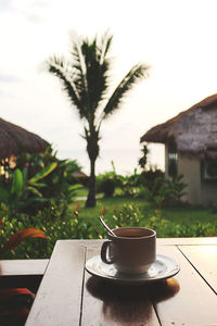 Coffee cup on table against building