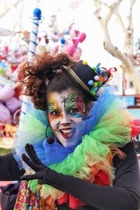 Portrait of happy mid adult woman in face paint standing outdoors