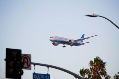 Low angle view of airplane flying against sky