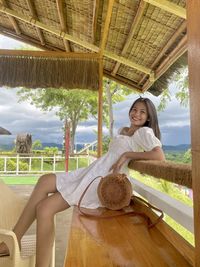 Portrait of young woman sitting on hammock