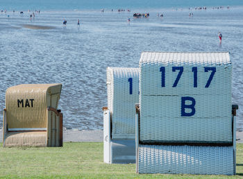 Hooded beach chairs on shore