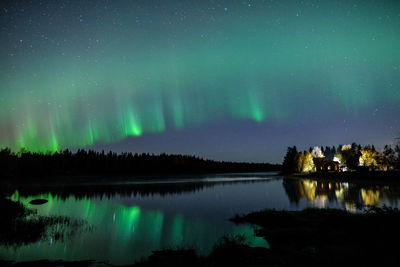 Scenic view of lake against sky at night