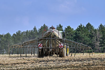 Traditional windmill on field against sky