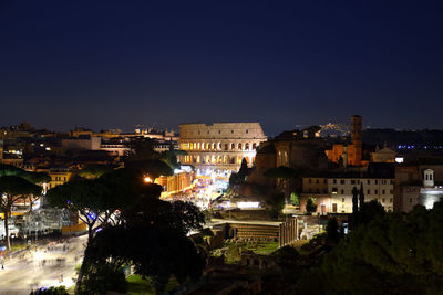 High angle view of illuminated buildings against clear sky at night