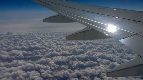 Airplane wing against sky