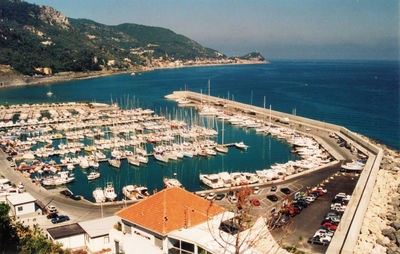 High angle view of city by sea against sky