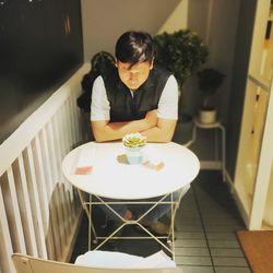 Man sitting by table at cafe