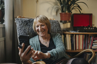 Senior woman using smart phone at home