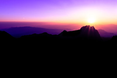 Scenic view of silhouette mountains against sky at sunset