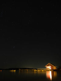 Illuminated building against sky at night