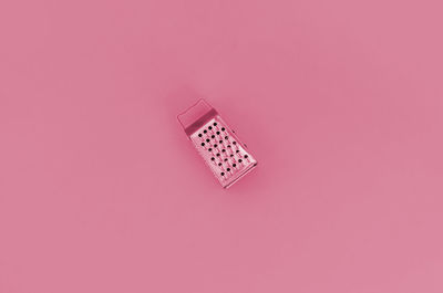 High angle view of dices on pink background