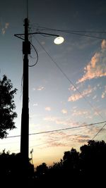 Low angle view of silhouette street light against sky