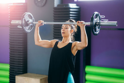 Young woman exercising in gym