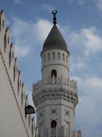 Low angle view of church against cloudy sky