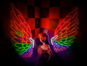 Close-up of light painting wings against black background