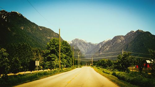 Empty road leading towards mountains