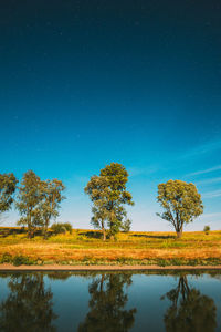 Scenic view of lake against sky at night