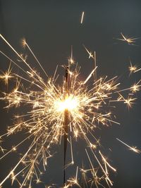 Low angle view of firework display against sky at night