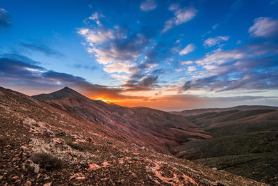 Scenic view of mountains against cloudy sky