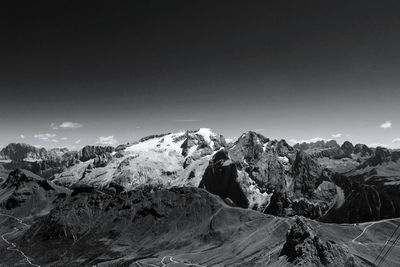 Aerial view of snowcapped mountains against clear sky