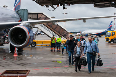 People working at airport runway