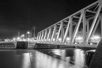 Night view of illuminated bridge above of river scheldt in antwerp, belgium