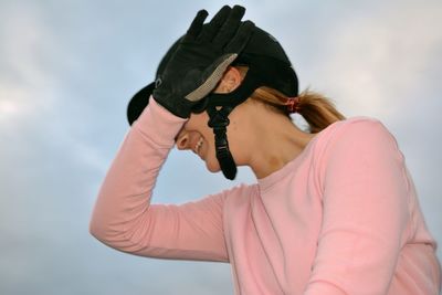 Low angle view of woman standing against sky