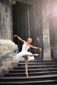 Woman walking on staircase of building