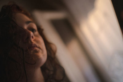 Close-up portrait of woman relaxing at home