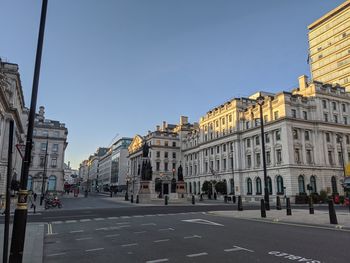 View of city street and buildings against sky