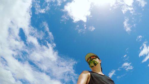 Low angle view of man standing against sky