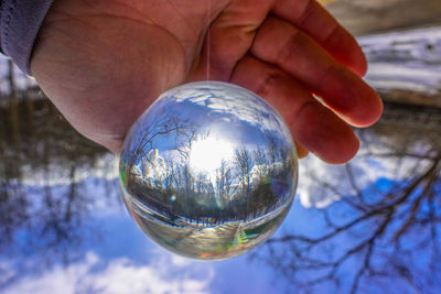 Close-up of hand holding crystal ball