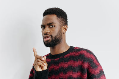 Young man standing against white background