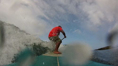 Close-up of man paddleboarding