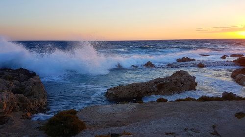 Scenic view of sea against clear sky during sunset