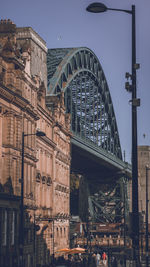 Bridge in city against sky