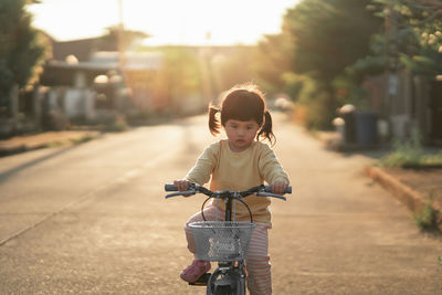 Boy riding bicycle on road