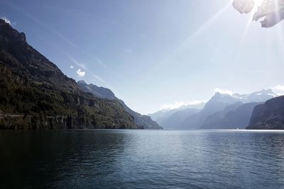Scenic view of lake and mountains against sky