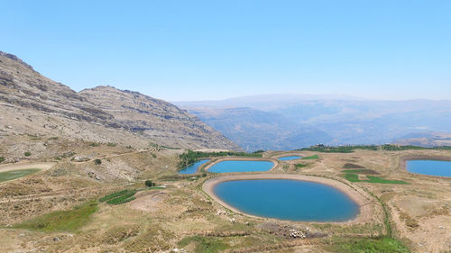 Scenic view of mountains against clear blue sky