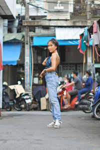 Full length of woman on street in city