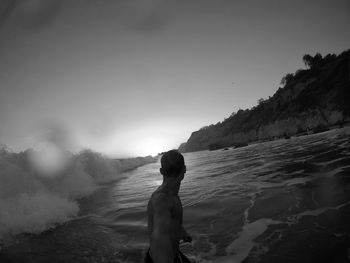 Man looking at sea against sky