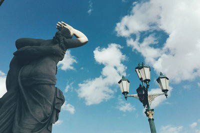 Low angle view of statue against street light