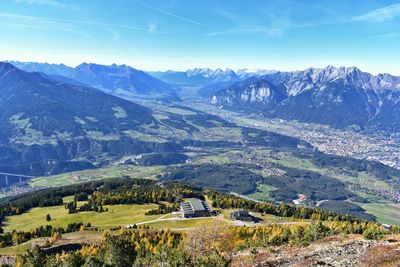 Scenic view of field and mountains against sky