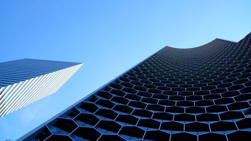 Low angle view of buildings against clear blue sky