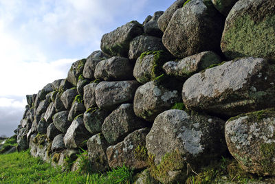 Stack of rocks on land against sky